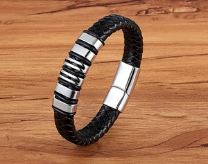 Detail of men's black braided leather bracelet with stainless steel rings and magnetic clasp