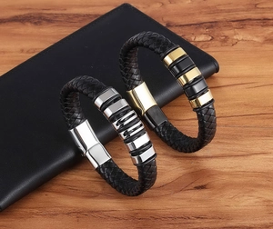 Detail of woven leather bracelets with magnetic clasps and gold-tone metal accents