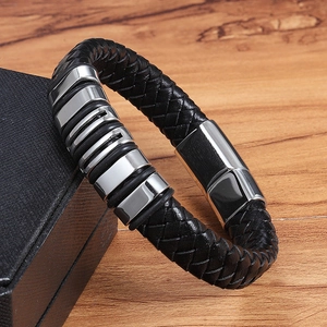 Braided black leather men's bracelet with stainless steel rings on a gift box