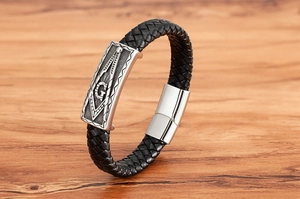 Close-up of black braided leather bracelet with silver Freemasonry symbol and magnetic clasp