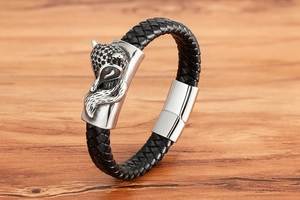 Close-up of black braided leather bracelet featuring a detailed silver fox head and magnetic clasp