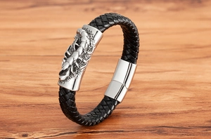 Detail shot of men's punk woven leather bracelet with silver metal scorpion charm