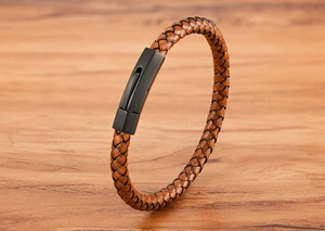 Detailed macro view of dark brown braided leather cord with matte black stainless steel buckle