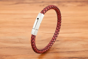 Macro detail of red braided leather cord and matte silver stainless steel magnetic clasp