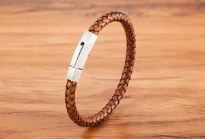Close-up of hand-woven brown leather bracelet with brushed silver stainless steel clasp