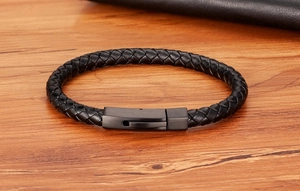 Close-up of black braided leather men's bracelet with a matte black metal clasp