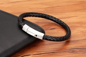 Close-up of black braided leather bracelet with brushed silver magnetic metal clasp