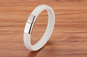 Gros plan d'un bracelet en cuir tressé blanc avec fermoir magnétique en argent