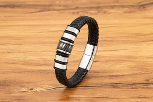 Close-up of black braided leather men's bracelet with stippled stainless steel beads