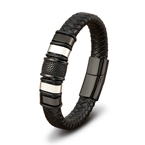 Detailed close-up of men's black braided leather bracelet with textured metal rings