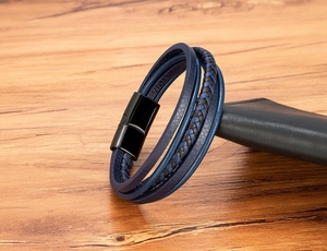 Detail showing multi-layer blue leather braided bracelet with black matte magnetic clasp