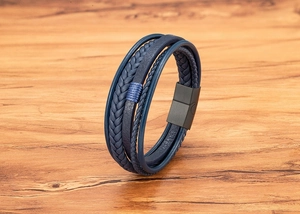 Macro detail of multi-layer navy leather braided bracelet with black matte magnetic buckle