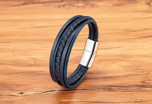 Detailed close-up of blue braided leather bracelet with silver magnetic metal clasp