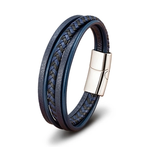 Macro detail of multi-layer blue leather braided bracelet with polished magnetic clasp