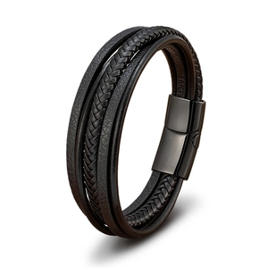 Detail of multi-layer black braided leather bracelet with matte magnetic metal clasp