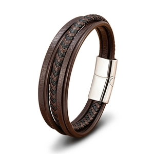 Detail of multi-layer woven leather cord bracelet with polished silver magnetic clasp