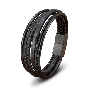 Detail of multi-layer braided black leather bracelet with matte metal magnetic clasp