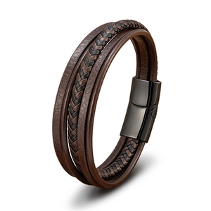 Close-up of multi-layer brown leather bracelet with black magnetic metal clasp