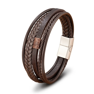 Detailed view of men's multi-layer brown braided leather bracelet with silver magnetic clasp
