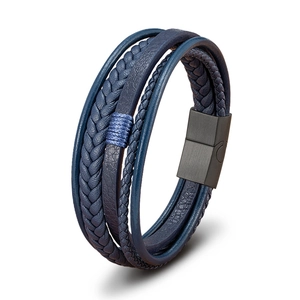 Detail of dark blue multilayer leather bracelet with braided strands and black magnetic clasp