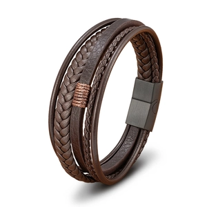Detail of multi-layer brown braided leather bracelet with a magnetic metal clasp