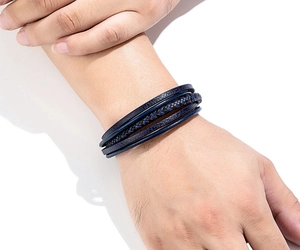 Detail of navy blue multi-layer braided leather bracelet for men with steel clasp