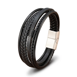 Close-up of multilayered black braided leather bracelet with silver magnetic metal clasp