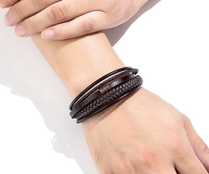Close-up of men's multi-layer braided brown leather bracelet with woven rope texture