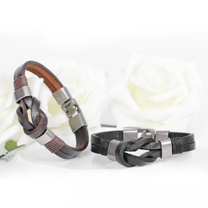 Men's vintage braided leather bracelet with matte metal buckle on white rose background