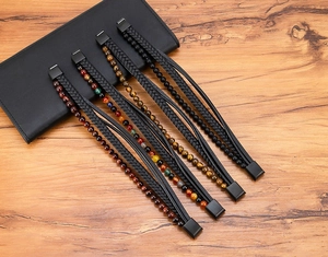 Detail of multi-layer leather bracelets with tiger eye stones and magnetic metal clasp