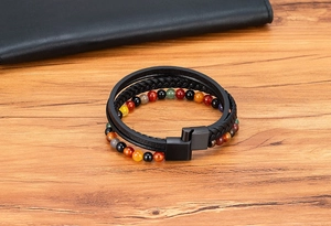 Detail of multi-layer leather bracelet with Tiger Eye stones and black metal buckle
