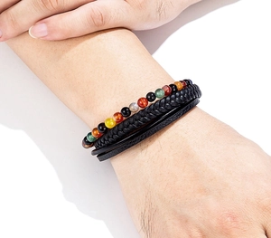 Detail of multi-layer leather bracelet with Tiger Eye stones on a male wrist