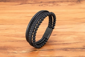Detail view of multilayer leather bracelet with matte beads and black magnetic clasp