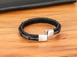 Detail view of multi-layer black leather bracelet with metal chain and brushed steel clasp