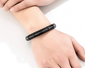 Detailed close-up of men's leather braided bracelet with stainless steel chain accent