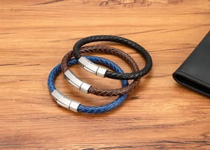 Detailed view of woven leather bracelets in black, brown and blue with matte metal clasps