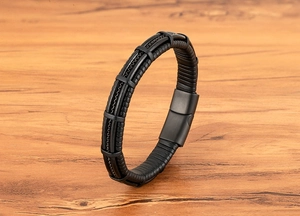 Close-up of men's multilayer black leather bracelet with matte metal magnetic clasp