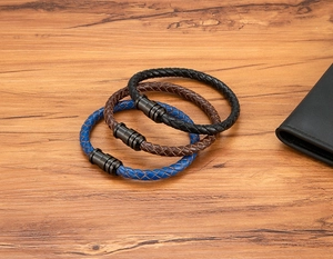 Close-up of woven leather bracelets in blue, brown, and black with matte magnetic clasps