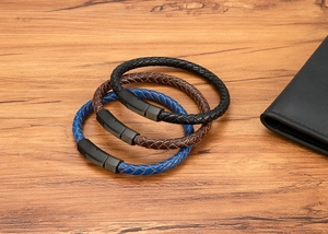 Detail of woven leather bracelets in black, brown and blue with matte metal hexagonal clasp