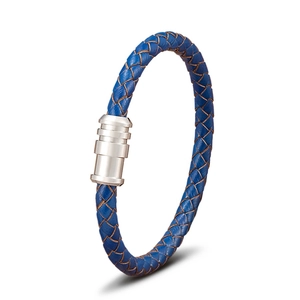 Close-up of blue braided leather bracelet featuring a polished silver magnetic clasp