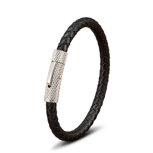 Detail van zwarte gevlochten leren armband met een zilveren metalen sluiting met karteling