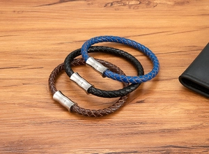 Detailed macro view of woven leather bracelets with textured magnetic stainless steel clasps
