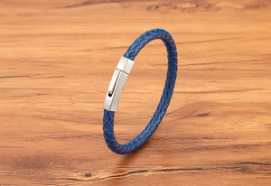 Close-up of navy braided leather bracelet with a matte silver hexagonal clasp