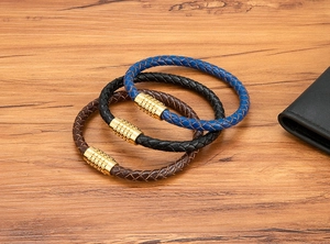 Detail of woven leather bracelets with magnetic clasps in navy, black, and brown