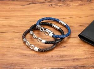 Detailed macro view of woven leather bracelets with infinity symbols and magnetic clasps