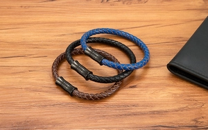 Close-up of woven leather bracelets in blue, black and brown with magnetic metal clasps