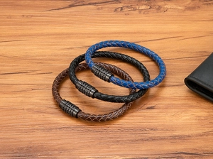 Detailed macro view of woven leather bracelets with textured magnetic steel clasps