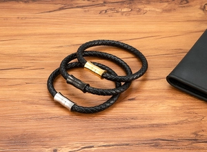 Close-up of woven leather bracelets with magnetic clasps in gold, silver and black