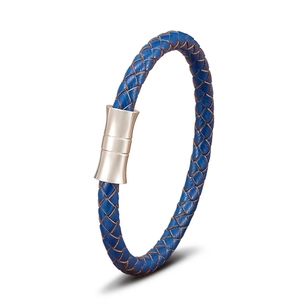 Macro view of blue braided leather cord with silver magnetic clasp on a steel bracelet