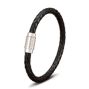 Macro detail of black braided leather texture and silver magnetic steel clasp on bracelet